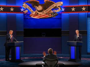 U.S. President Donald Trump and Democratic Presidential candidate and former U.S. Vice President Joe Biden exchange arguments as moderator and Fox News anchor Chris Wallace raises his hands to stop them during the first presidential debate on Sept. 29, 2020.