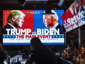 Television screens airing the first presidential debate Tuesday are seen in a Washington, D.C. sports bar.