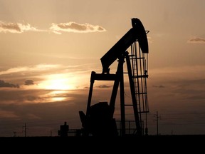 An oil pump jack stands alone at sunset near Midland, Texas. Big oil in the U.S. has been slower on the turn to renewable energy.