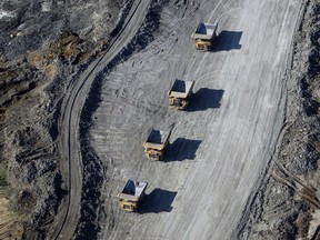 Dump trucks carrying oilsands at a Suncor Energy mine.