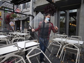 A worker dismantles a restaurant terrace in Montreal, on Oct. 1. Services are really going to struggle in the second wave, Frances Donald says.