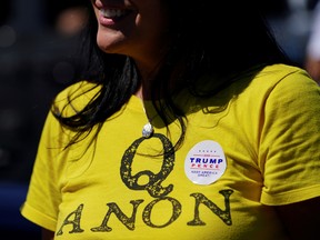 A supporter of U.S. President Donald Trump wears a QAnon shirt.
