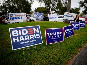 Campaign signs are seen at Westchester Regional Library in Miami, Florida on October 19, 2020.