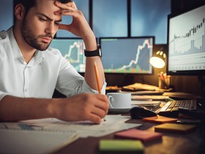 Serious businessman thinking of problem solution working late in office