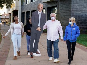 A cardboard cutout of U.S. Democratic presidential candidate Joe Biden is carried near the site where he is expected to claim victory in Wilmington, Del.