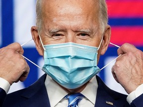 Democratic U.S. presidential nominee Joe Biden removes his face mask to speak about the 2020 U.S. presidential election results during an appearance in Wilmington, Delaware, U.S., November 4, 2020.