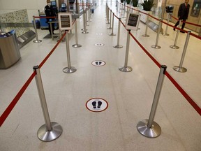 An empty security queue with social distancing markers is seen at Toronto Pearson International Airport.