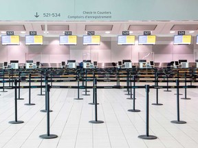 An empty check-in counter at Toronto Pearson International Airport. Air passenger traffic plummeted nearly 90 per cent this summer.