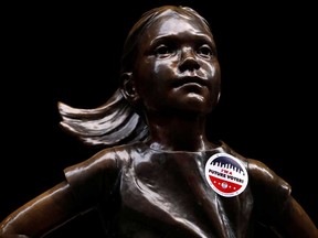 "I'm a Future Voter" sticker is seen on the Fearless Girl statue on Election Day outside the New York Stock Exchange. North American indexes surged following Tuesday’s vote.