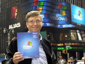Microsoft Chairman Bill Gates holds up a copy of the new Windows XP operating system in New York's Times Square in October, 2001. At the end of 2002, the tech giant's shares flatlined until 2008.
