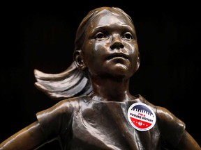 "I'm a Future Voter" sticker is seen on the Fearless Girl statue on Election Day outside the New York Stock Exchange.