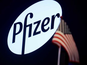 A logo for Pfizer is displayed on a monitor on the floor at the New York Stock Exchange.