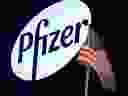 A logo for Pfizer is displayed on a monitor on the floor at the New York Stock Exchange.
