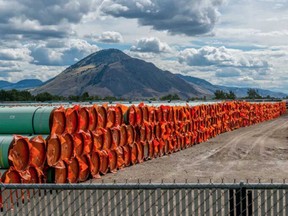 Steel pipe to be used in the oil pipeline construction of the Trans Mountain Expansion Project lies at a stockpile site in Kamloops, British Columbia earlier this year.