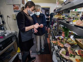 The Danish Place’s Anna Lewis, right, works on orders with an employee on their last day of operation, Nov. 1, 2020.