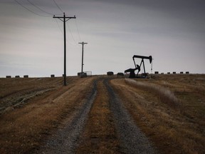 A pumpjack works at a well head on an oil and gas installation near Cremona, Alta.