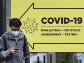 A man walks past a COVID-19 testing clinic in Montreal, in October.