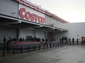 Shoppers queue outside a Costco wholesale store in Leeds, northern England, ahead of a second lockdown.