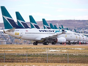 WestJet jets stored on an unused runway at Calgary International Airport on Wednesday, Oct. 14, 2020.