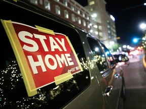 'Stay Home' sign is taped to a vehicle participating in a car caravan of nurses calling for people to stay inside amid a surge of COVID-19 cases in El Paso, Texas.