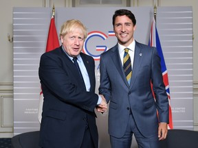 Britain's Prime Minister Boris Johnson shakes hands with Canada's Prime Minister Justin Trudeau at the G7 summit in Biarritz, France, August 24, 2019.