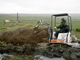 In this July 13, 2007, file photo, a worker with the Pebble Mine project digs in the Bristol Bay region of Alaska near the village of Iliamma, Alaska.