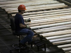 n employee monitors production at the West Fraser Timber Co. sawmill in Quesnel, British Columbia.