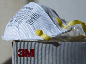 A 3M particulate respirator: 3M is cutting about 2,900 jobs globally and scaling back on investments in slower-growing markets.