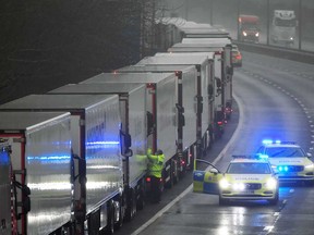 Trucks unable to cross to France sit parked on the motorway towards the Eurotunnel and the Port of Dover, after EU countries imposed a travel ban from the U.K. because of a surge in the threat of coronavirus.