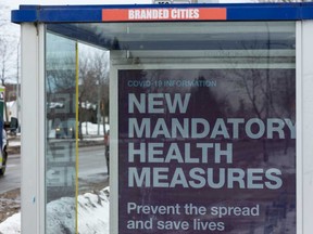 A sign in a bus stop announces health measures during the COVID-19 pandemic.