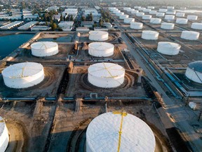 Oil-storage tanks are seen from above in Carson, California. Global tanks will hold 625 million barrels more crude at the start of 2021 compared with pre-pandemic levels, an overhang that will dissipate by next December, the IEA said.