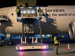 Canada's first batch of Pfizer/BioNTEch COVID-19 vaccines are unloaded from a UPS cargo plane at Montreal-Mirabel International Airport in Montreal on Dec. 13.
