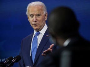 U.S. President-elect Joe Biden points to Wally Adeyemo, Biden's nominee to be deputy treasury secretary, as he announces nominees and appointees to serve on his economic policy team at his transition headquarters in Wilmington, Delaware.
