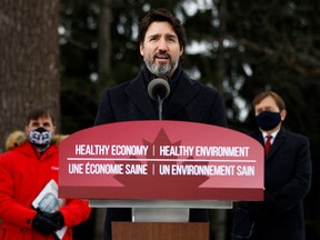 Prime Minister Justin Trudeau, with Minister of Canadian Heritage Steven Guilbeault, left, and Minister of the Environment and Climate Change Jonathan Wilkinson at the climate plan news conference on Friday.