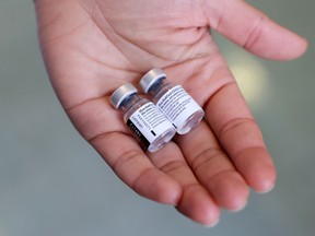 A pharmacist holds the Pfizer-BioNTech coronavirus disease (COVID-19) vaccine.
