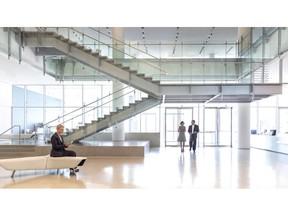 Lobby of an office building facing the entrance with persons walking into the building.