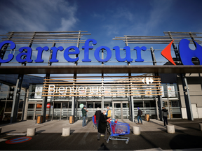 Customers walk past a Carrefour Hypermarket store in Saint-Herblain near Nantes, France January 15, 2021.