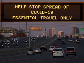 A digital sign telling motorists to limit travel during the coronavirus outbreak, is seen on a highway sign in Toronto.