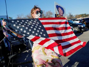 A supporter holds a U.S. flag during a campaign rally on Jan. 3 ahead of Georgia's runoff elections in Savannah, Georgia.