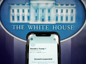 A photo illustration shows the suspended Twitter account of U.S. President Donald Trump on a smartphone at the White House briefing room in Washington.