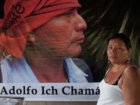 Angelica Choc stands in front of a banner with an image of her slain husband, former Q'eqchi' Mayan community leader, teacher and anti-mining activist Adolfo Ich Chaman, on the fifth anniversary of his murder.