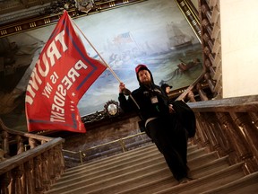 A protester holds a Trump flag inside the U.S. Capitol Building near the Senate Chamber on January 6, 2021 in Washington, D.C.