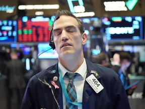 Traders work on the floor at the closing bell of the Dow Industrial Average at the New York Stock Exchange on March 11, 2020 in New York.