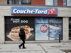 A pedestrian walks past a Couche-Tard convenience store in Montreal.