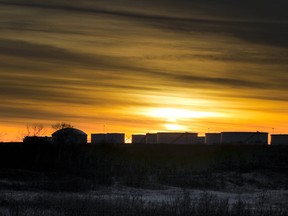 The sun rises on large oil tanks near the town of Hardisty, Alberta.