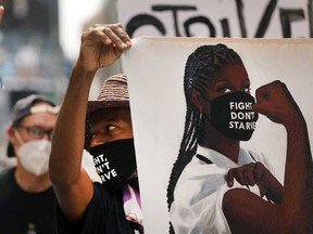 Activists from One Fair Wage hold a demonstration in New York's Times Square this past August. The One Fair Wage campaign seeks to lift millions of tipped and sub minimum wage workers out of poverty.