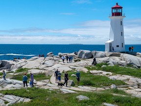 Visitors explore Peggy's Cove, N.S., in July 2020. Atlantic Canada was quick to close its borders when COVID-19 struck and clever enough to create the so-called Atlantic Bubble in early July to keep people and tourist dollars circulating.