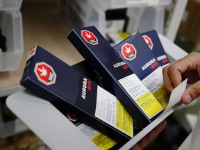 An employee holds a tray of Aurora Cannabis Inc. Drift brand edibles inside the Hobo Cannabis Co. store in Ottawa.