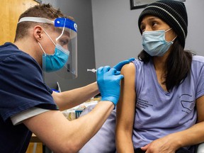 A woman receives a COVID-19 vaccine in Massachusetts.