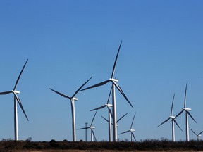 Wind turbines against a blue sky at a wind farm in Texas.